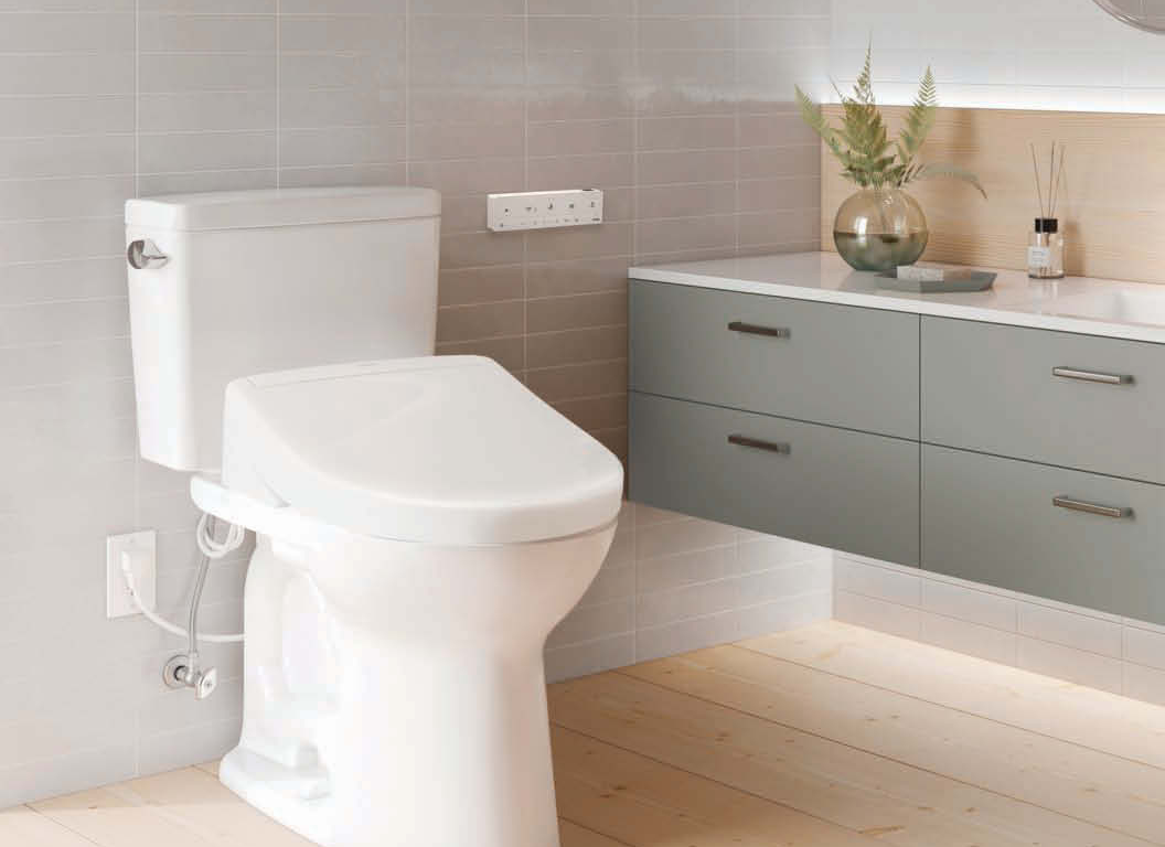 TOTO Drake WASHLET+ S5 two-piece toilet in a modern bathroom with grey tile and a light wood floor