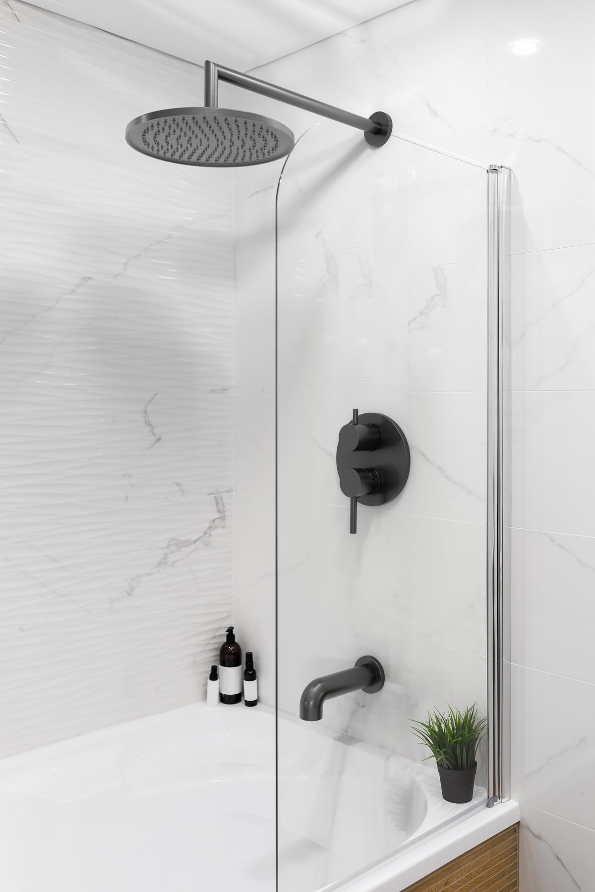 Baril BEC-0520-73 tub spout in Black Titanium, shown in a bathroom setting with other fixtures sold separately